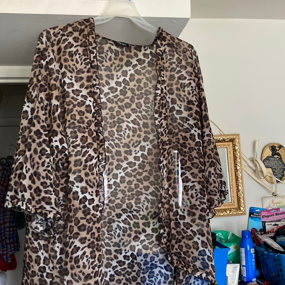 Women’s sheer animal print cover shirt with ruffled front and sleeves